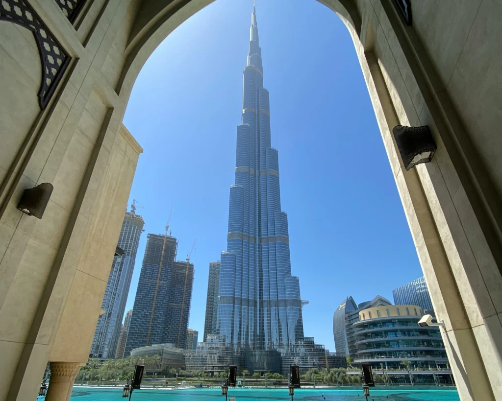 People Walking on Sidewalk Near High Rise Buildings