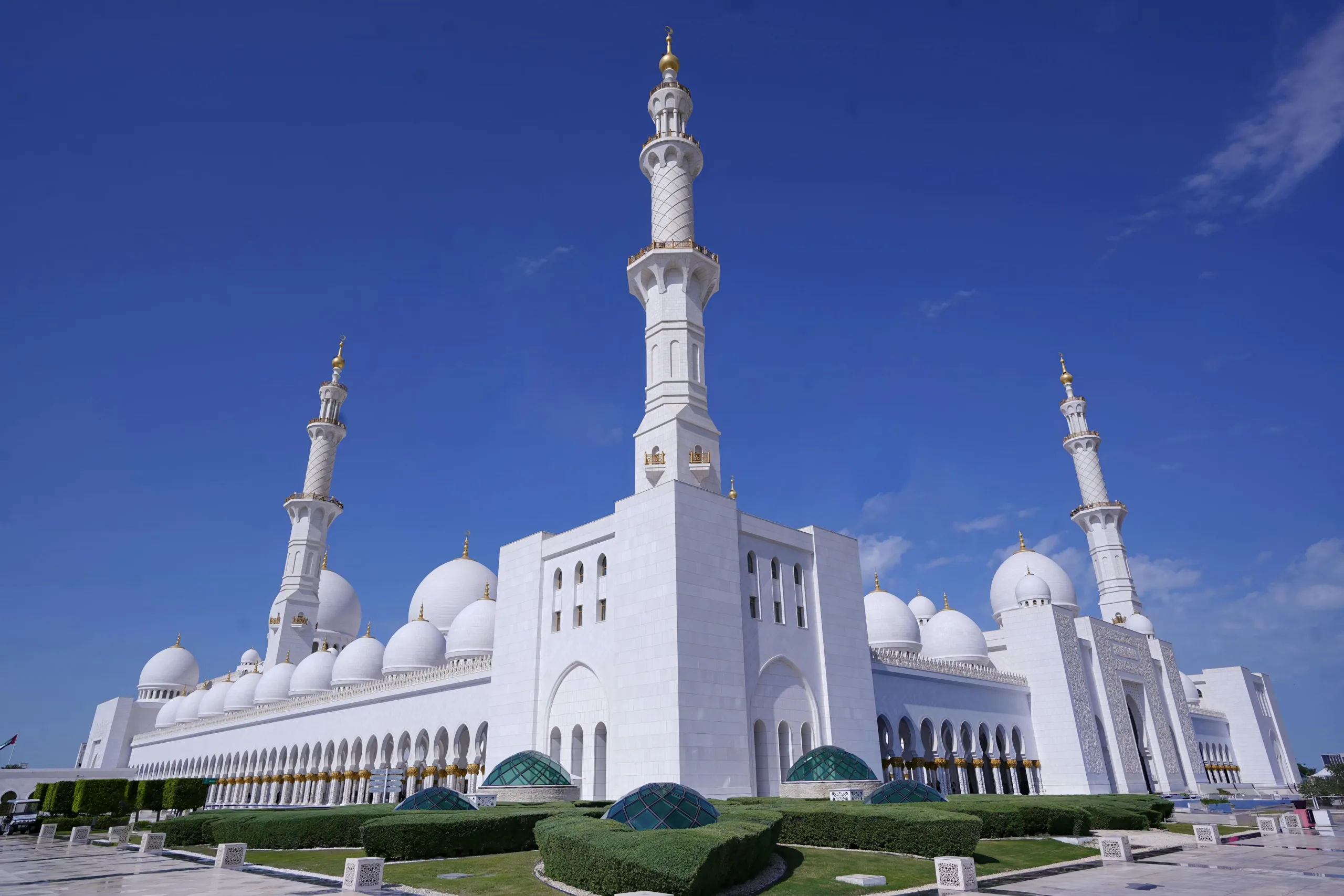 Sheikh Zayed Grand Mosque in Abu Dhabi with stunning white marble domes, minarets, and reflective pools.